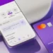 "Imagem do aplicativo Nubank com cartão roxo, mostrando informações sobre empréstimos consignados.