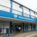 Fachada do INSS com pessoas entrando para solicitar prorrogação do auxílio-doença.