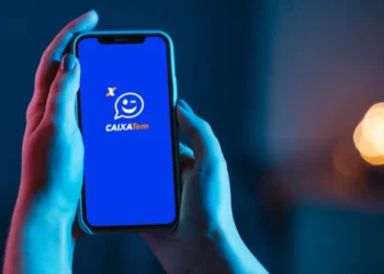 Aplicativo Caixa Tem aberto em smartphone mostrando serviço de recarga de celular e outros recursos financeiros.