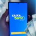 "Imagem do aplicativo Caixa Tem aberto em um smartphone, ilustrando o processo ágil e prático para acessar serviços financeiros."