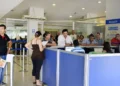 Pessoas aguardando atendimento em fila no balcão de uma agência do INSS