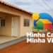 Imagem de casas do programa Minha Casa Minha Vida Rural com logo e texto sobre o contrato para 170 moradias.