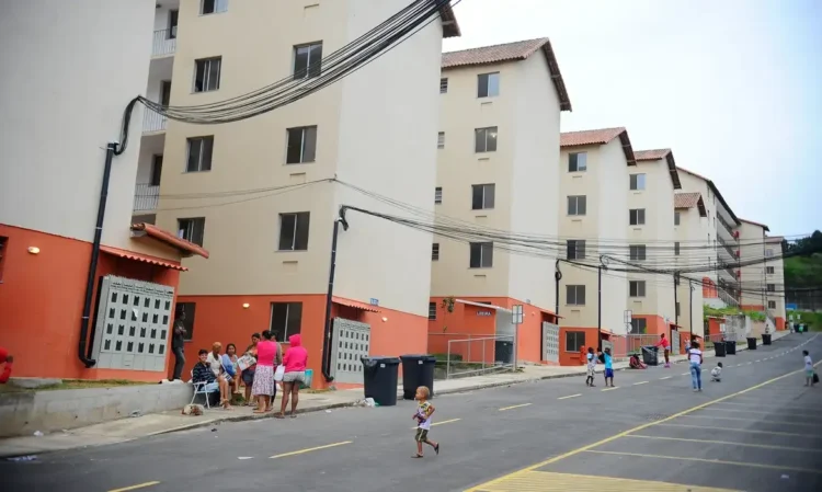 Conjunto habitacional com moradores e crianças em frente aos prédios