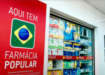 Fachada de uma Farmácia Popular com prateleiras de medicamentos e o logotipo do programa brasileiro.