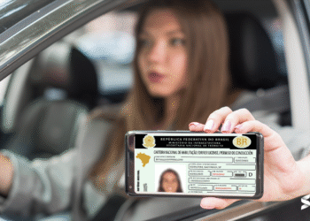 CNH digital brasileira sendo exibida em smartphone enquanto motorista está no carro, com a data limite para entrega de documentos para a CNH gratuita.