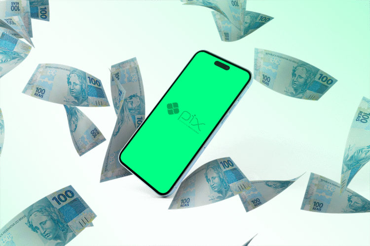 Celular com tela do Pix cercado por notas de cem reais.