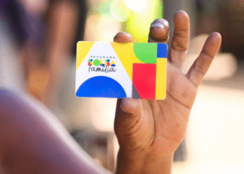 Cartão do Bolsa Família em destaque na mão de uma pessoa