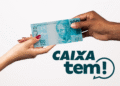 Duas pessoas trocando nota de 100 reais com logo do Caixa Tem, representando pagamento de benefícios.