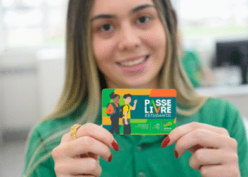 Estudante segurando o cartão do Passe Livre Estudantil.