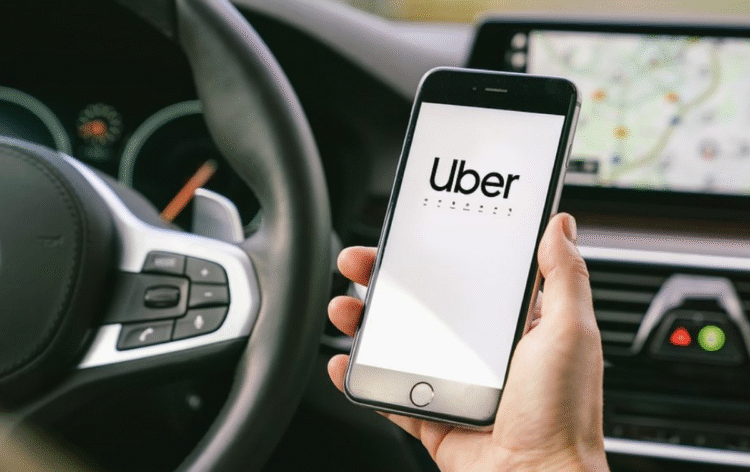 Aplicativo Uber aberto em um smartphone dentro de um carro