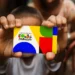 Criança segurando o novo cartão do Programa Bolsa Família com cores vibrantes