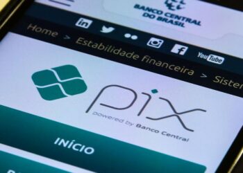 Tela de celular exibindo o logo oficial do Pix "powered by Banco Central" no site da instituição, simbolizando a notícia sobre o adiamento do lançamento do Pix Parcelado por questões de segurança contra fraudes e golpes milionários.