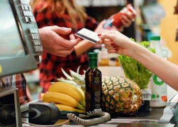 Cliente realizando pagamento com cartão em supermercado, refletindo o impacto das mudanças nas taxas de MDR no comércio.