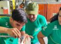Jovens e adultos participando de uma atividade prática ou treinamento profissional em uma oficina, com o logo da Petrobras em suas camisetas, simbolizando qualificação e autonomia.