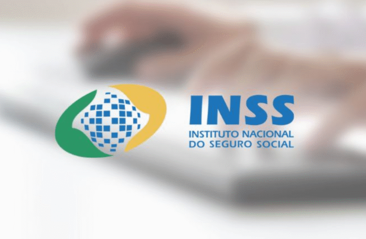 Logotipo do INSS sobre fundo desfocado com teclado.