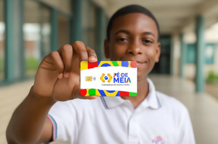 Estudante segurando o cartão do programa Pé-de-Meia.