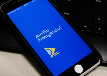 Smartphone mostrando a tela do aplicativo Auxílio Emergencial para acompanhamento de benefício